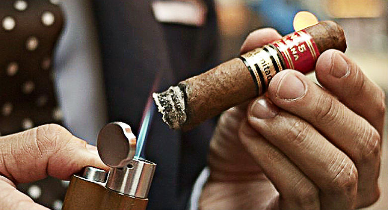 How to cut and light a cigar.