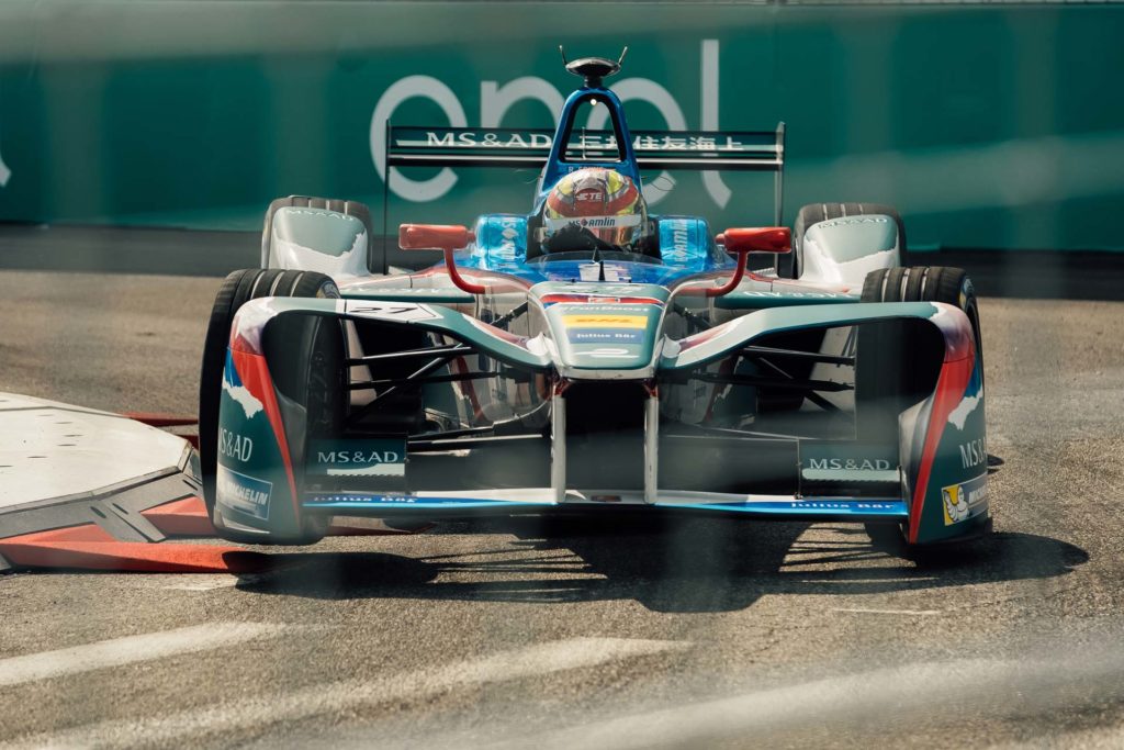 Formula E car taking a corner on the New York circuit.