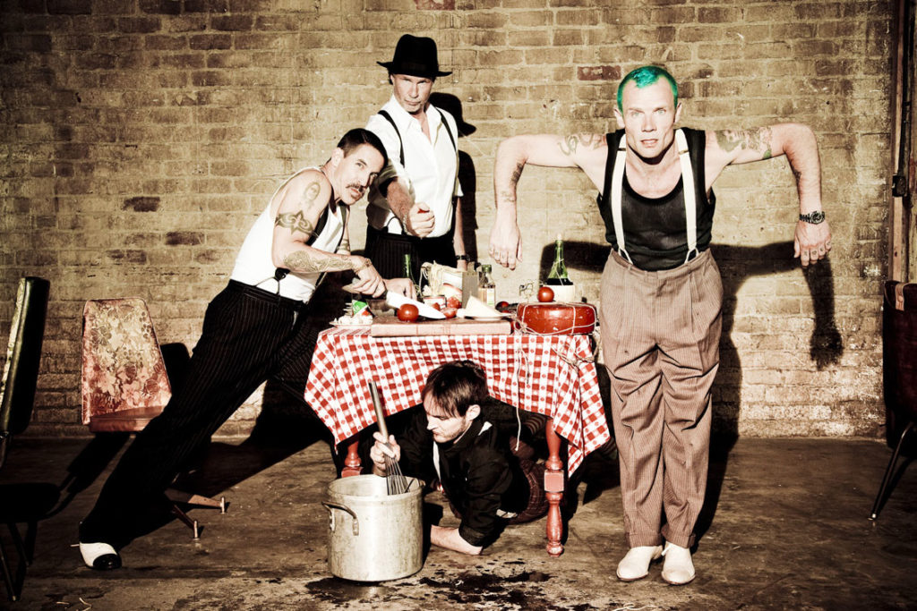 Red Hot Chili Peppers band mugging up to the camera in an official photoshoot.