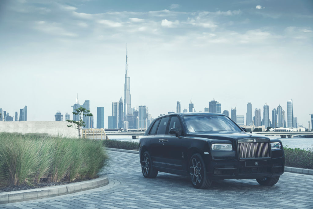 Rolls-Royce Cullinan Black Badge in front of Burj Khalifa in Dubai.