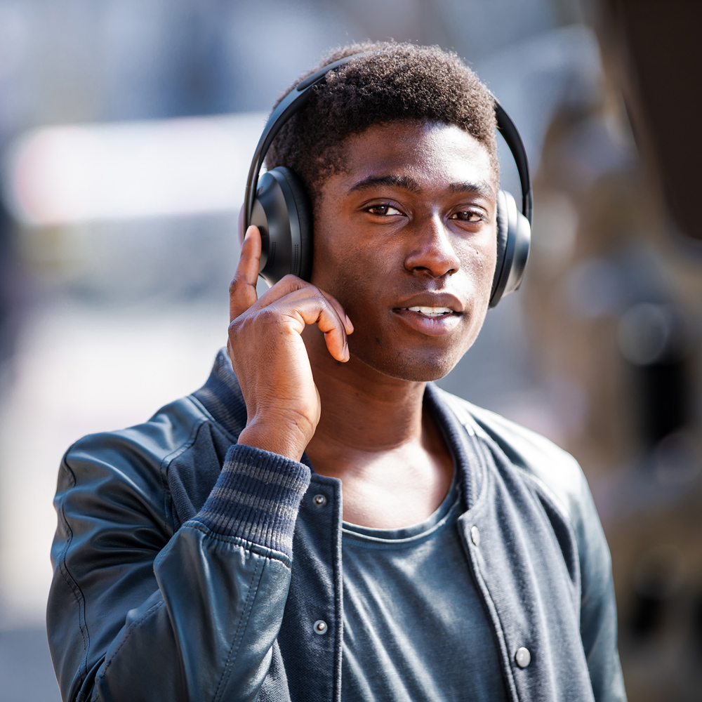 Model wearing Bose 700 headphones.