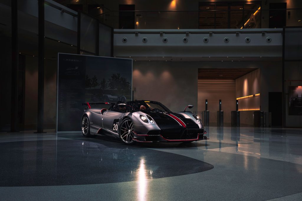 Pagani hypercar under moody lighting.